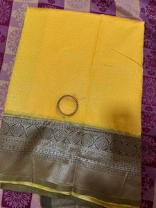 Elegant Yellow Art Silk Saree With A Classy Bangle