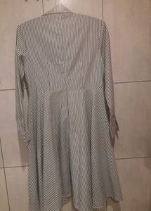 An Elegant Dress With Grey Stripes On White Base