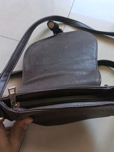 blue and dark brown sling bag