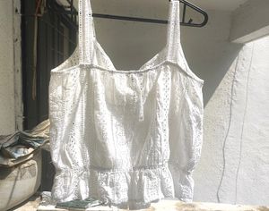 button-up tank top with spaghetti straps.