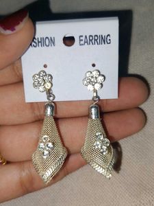 a pair of silver-toned, textured dangle earrings.