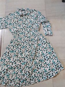 a middi of white colour having green nd black dots
