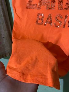 Soft Fabric,Cute Orange Bold Colour Top With Topography Print,medium In Size Bust Size -32, Can Pair It With Black Pant Or Dark Blue Jeans