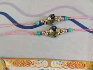 Set Of 2 Rakhis In Pastel Shade With Heavy Stone