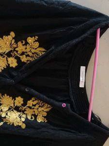 a long sleeves black top with boho vibes and also