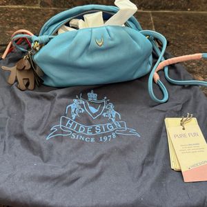 Hidesign sling with leather charm n dust bag