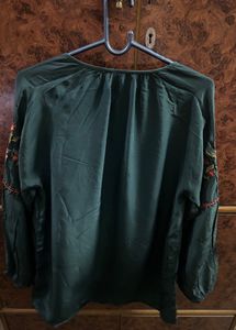 Bottle, green colour, full sleeves, top with elastic at the sleep, end and embroidery work in the front and in the arms of the top