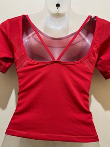 top features a V-shaped strap design at the back