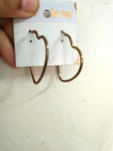 Two Heart Shaped Hoops In Gold .