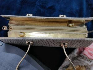 A brand new sparkly gold clutch