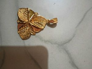 Gold-tone pendant with intricate woven texture