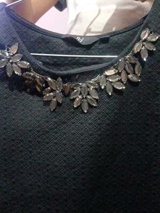 Textured Black Top with Leaf Embellishments