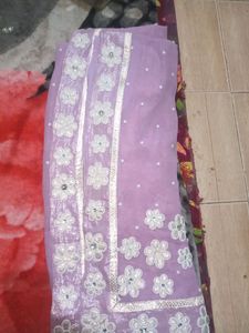 A very beautiful lavender colour saare with jdau work and shimmery padded blouse