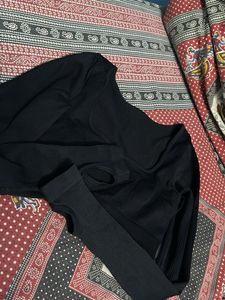 Black fitted long sleeve crop top with a thumbhole