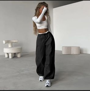 Black trendy parachute pants with adjustable lows