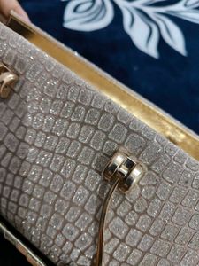 A brand new sparkly gold clutch
