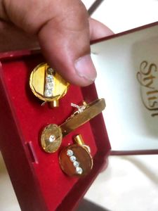 golden cufflinks and tie-pin
