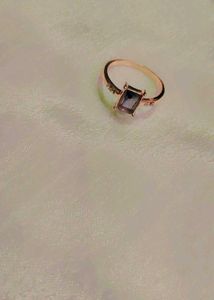 Elegant rose gold ring with a lavender stone.