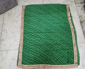 Green bandhni saree with golden border less