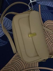 classy beige slingbad/handbag with two belts