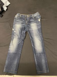 Distressed Mid-Wash Levi’s Jeans”