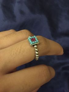 oxidised ring with terquoise and red beads.