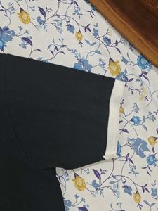This is a black polo tshirt.With white collar.