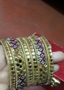Set of Gold Bangles with Red Accents