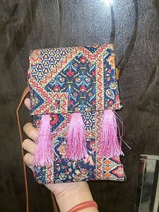 Vibrant Multicolored Sling Bag with Pink Tassels
