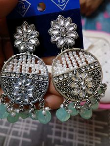 a pair of lightweight ethnic white earrings with