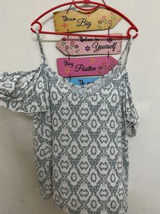 Cold-shoulder top with spaghetti straps.