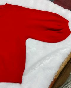red woolen top