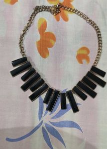 Black and gold neck piece