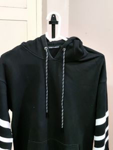 💥BUY1GET1💥 black hooded sweatshirt with white stripes on the sleeves.