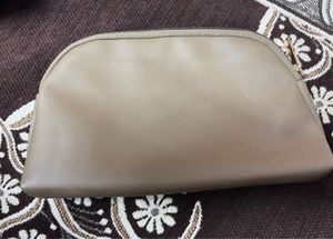 This is a taupe faux leather makeup bag