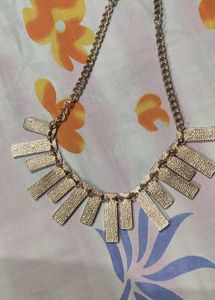 Black and gold neck piece