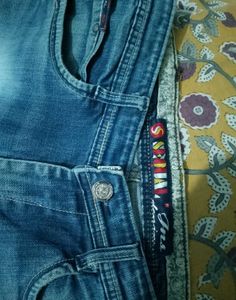 Distressed Jeans with Red and White Stripe