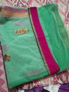 Saree half green and white combination.