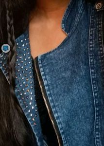 A Denim Jacket With Metallic Star Work On It