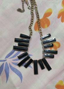 Black and gold neck piece