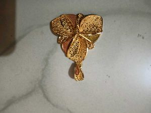 Gold-tone pendant with intricate woven texture