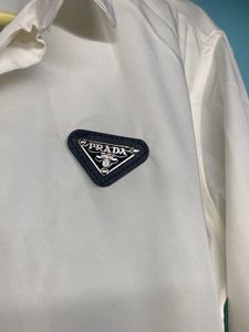 Elegant Minimalism: Prada White Triangle Logo Shir