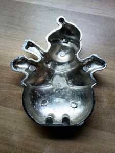 A Shiny Silver Snowman Figurine With Top Hat