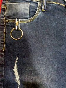 Distressed Jeans with Pom-Pom Hem