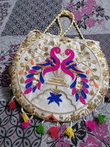 Cream Coloured Sling Bag With Multicolored Design.