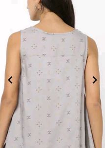 Patterned Sleeveless Top With Dipped Hem