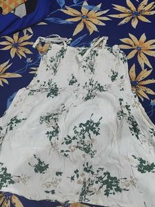 a white body fitted top in flower pattern