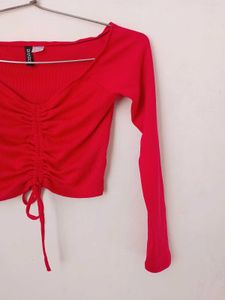 branded red long sleeves crop top.