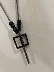 Transform any outfit with our geometric pendant