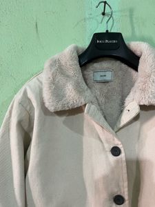 beige jacket with a faux fur collar and cuffs.